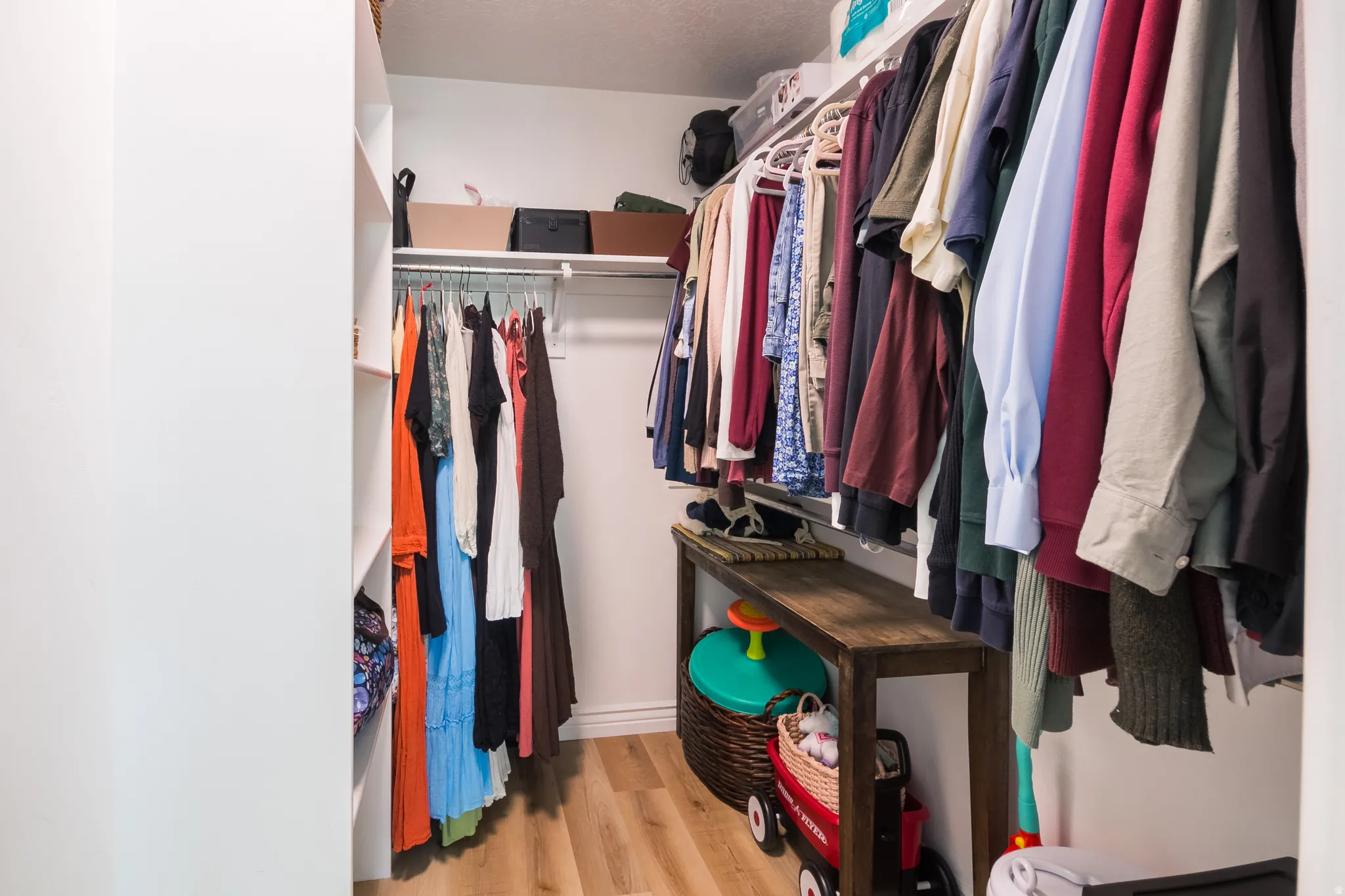 Walk in closet featuring light wood finished floors