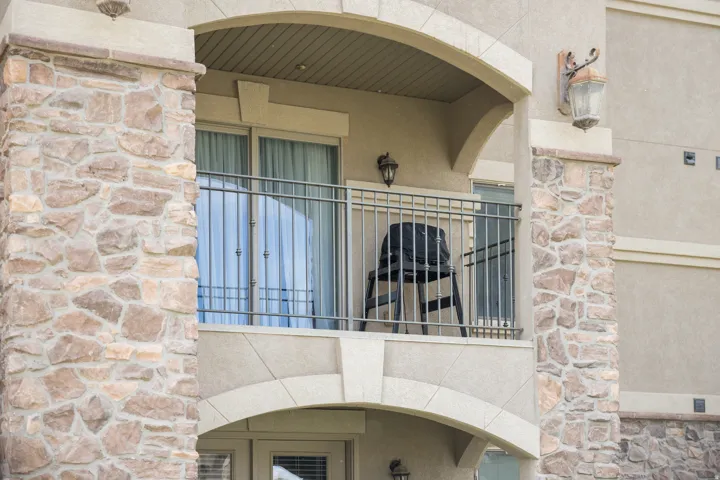 Exterior view of stone siding, arched walkways, and stucco siding