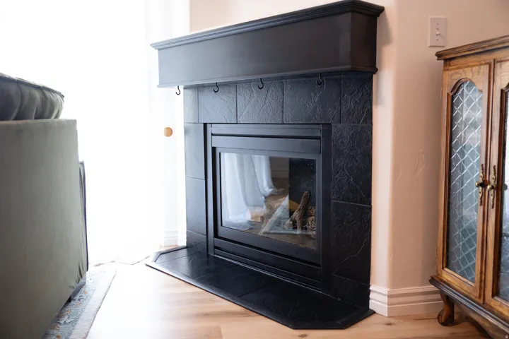 Detailed view of wood finished floors and a fireplace