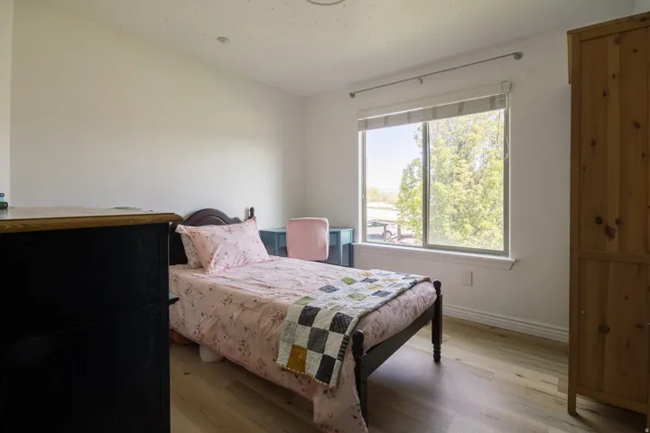 Bedroom featuring wood finished floors and baseboards