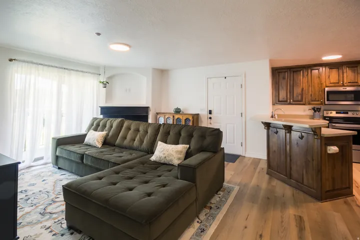Living room featuring light wood-type flooring and a textured ceiling