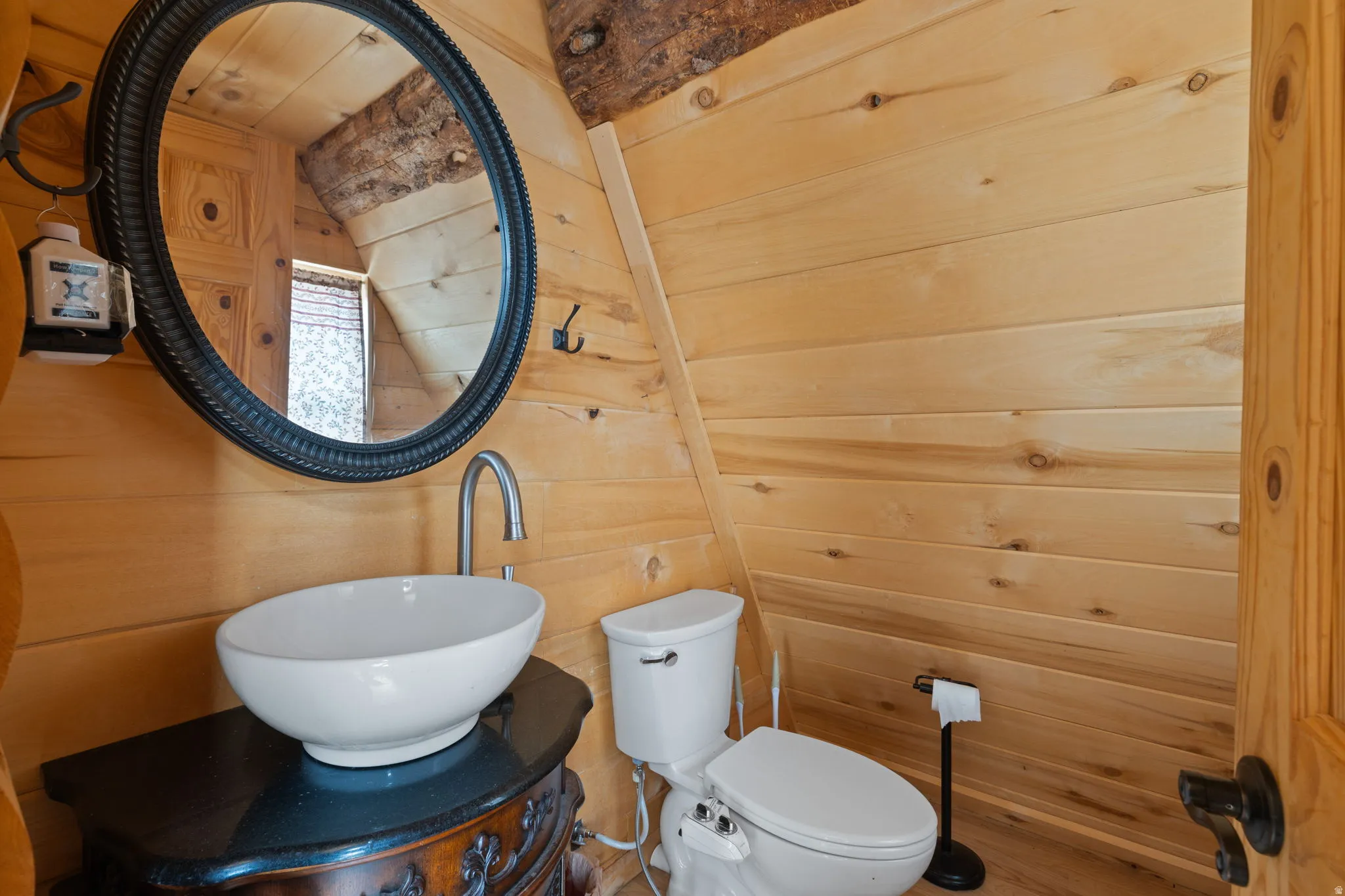 Half bath with wood walls and vanity