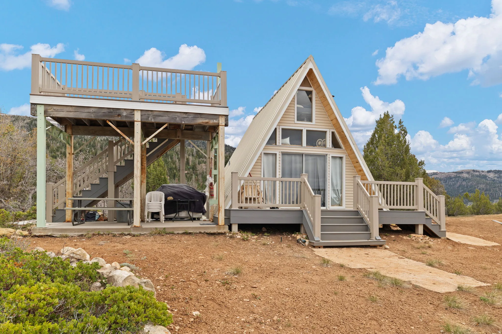 Rear view of property with stairway and a deck with mountain view