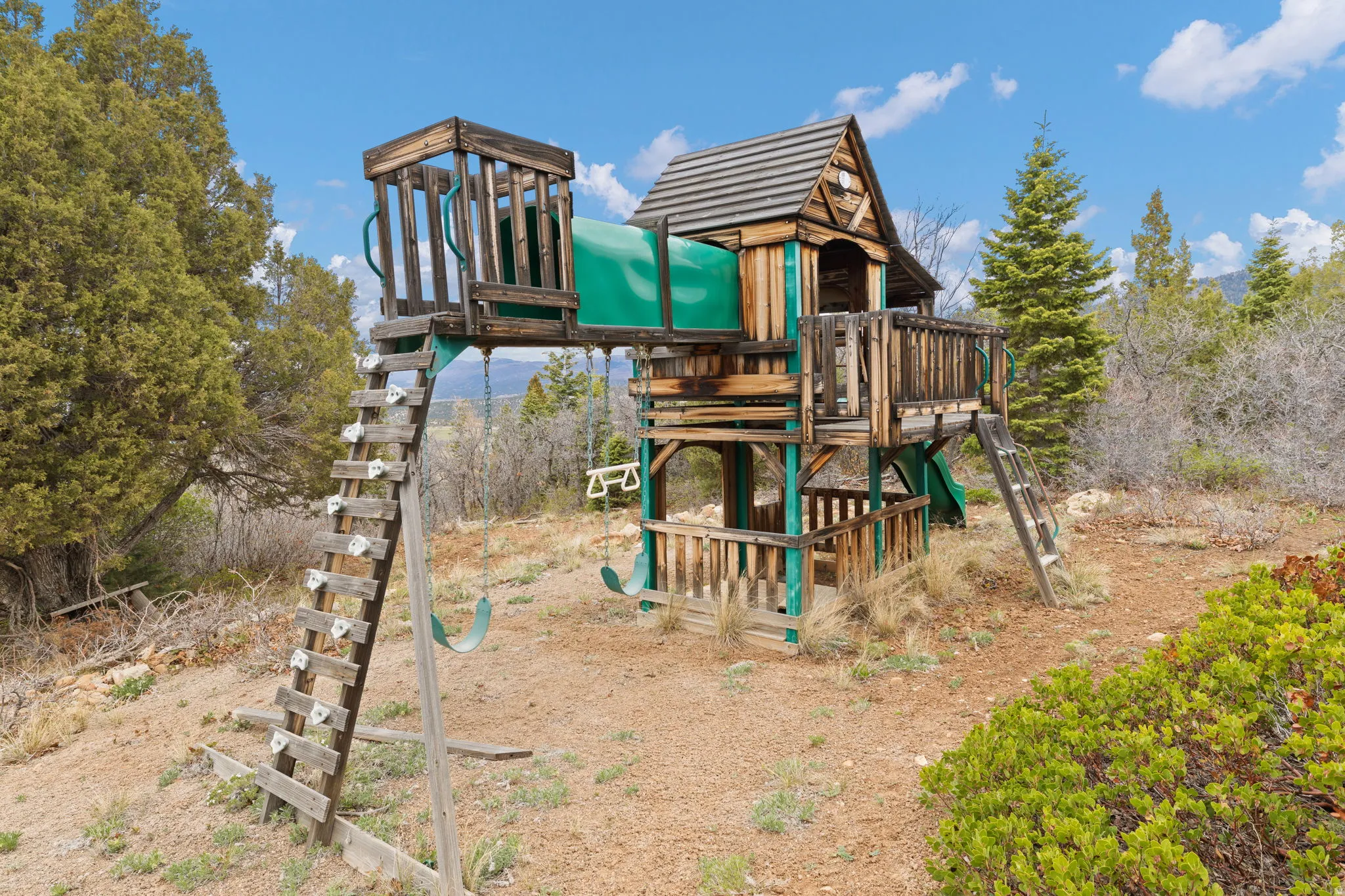 View of playground with view of scattered trees