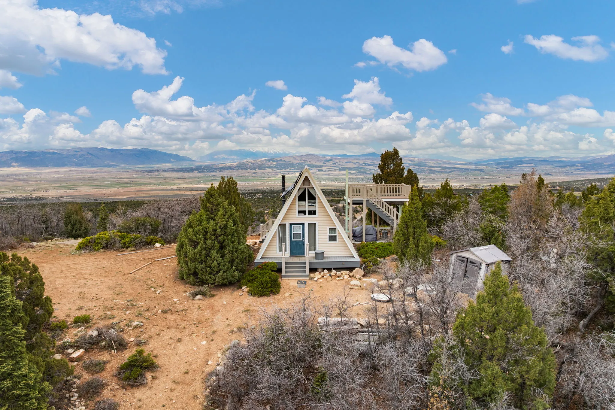 Rear view of house with a mountain view and an outdoor structure