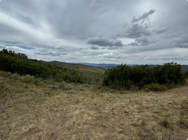 View of undeveloped land featuring mountains and rural landscape