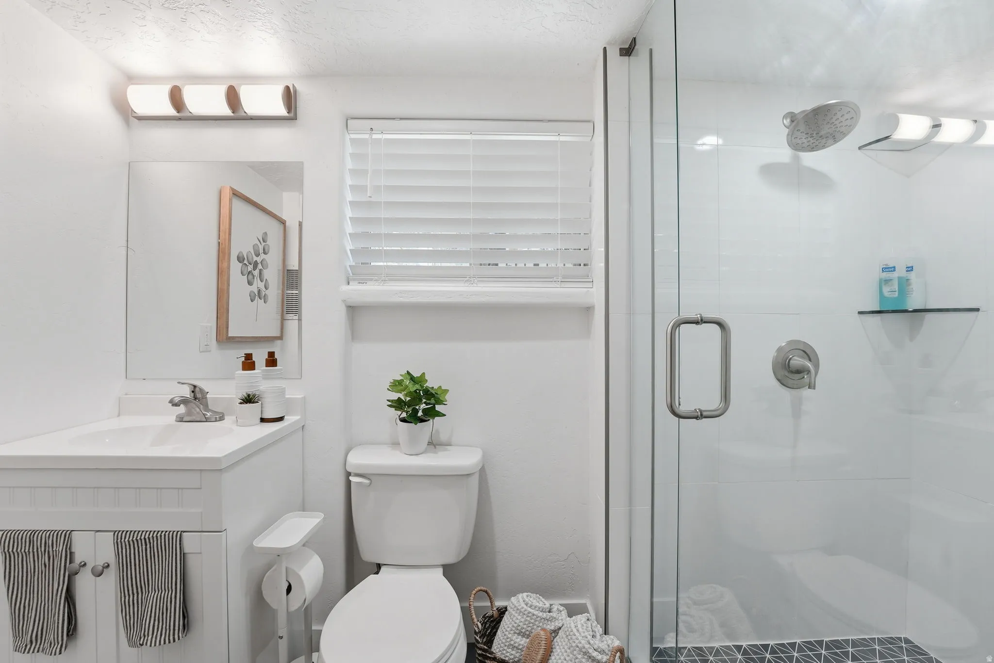 Bathroom with vanity and a shower stall