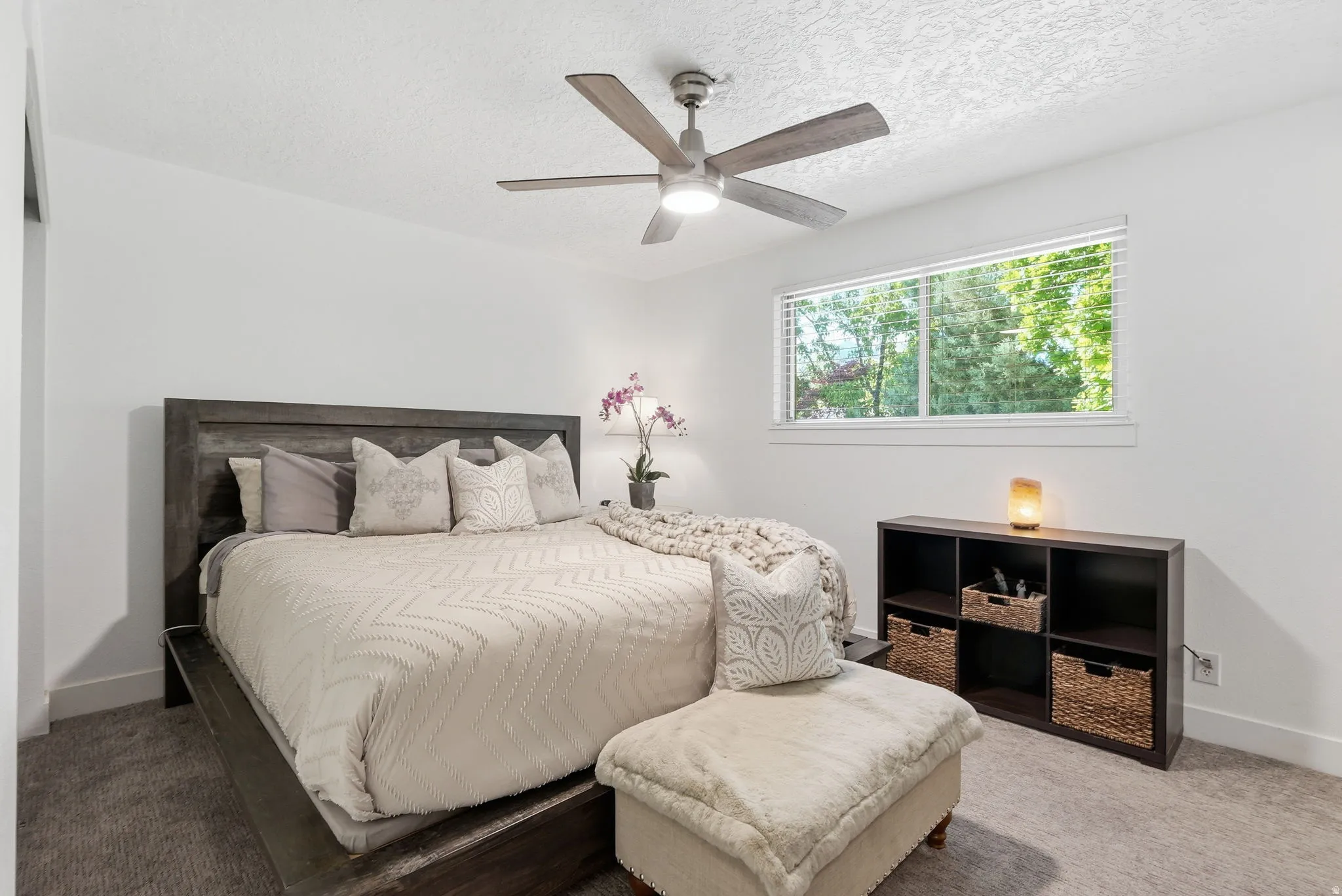 Bedroom featuring carpet floors, a textured ceiling, and a ceiling fan