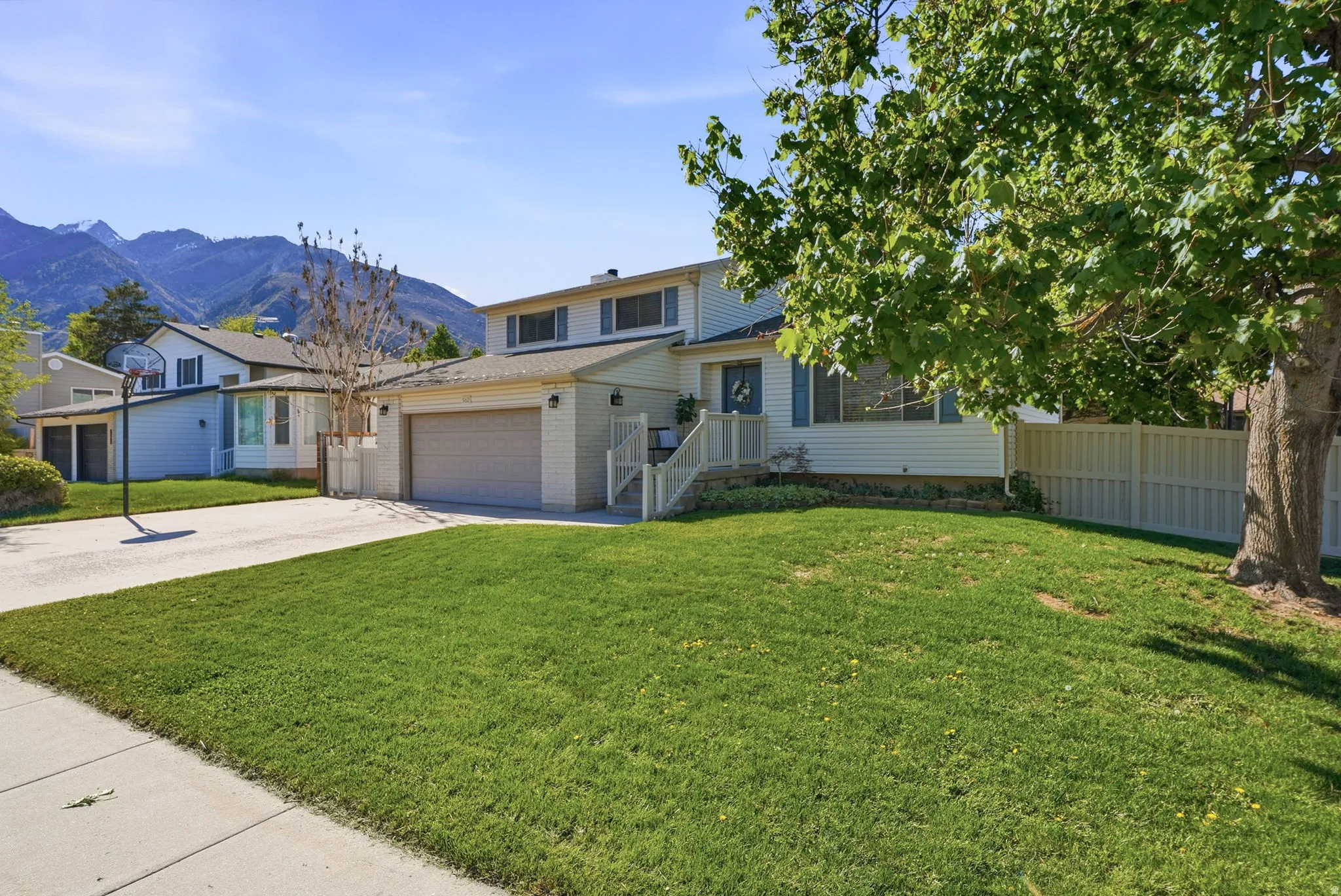 Traditional-style house featuring concrete driveway, a mountain view, and a garage