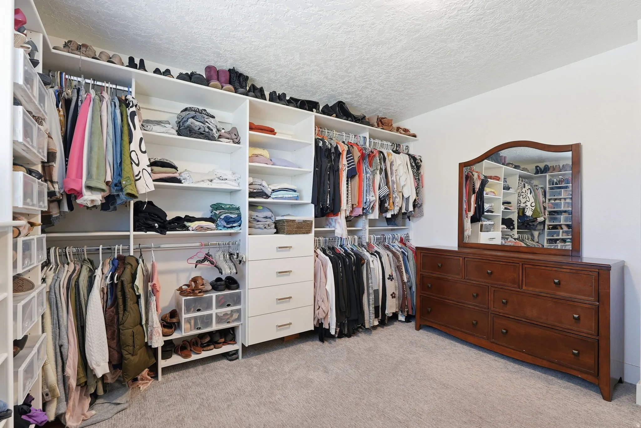 Bedroom or Walk in closet featuring light colored carpet
