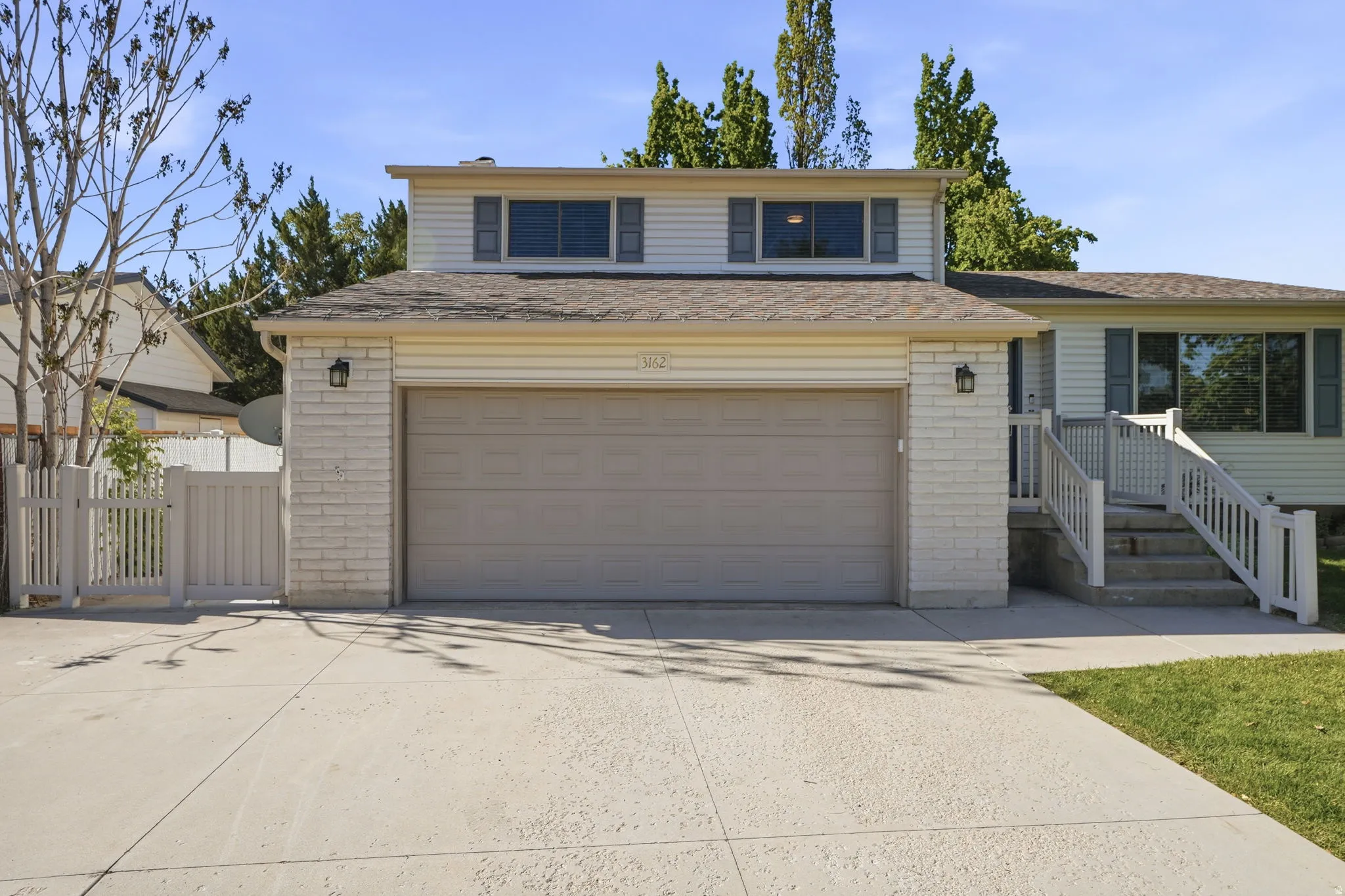 Traditional home with brick siding, driveway, and a garage