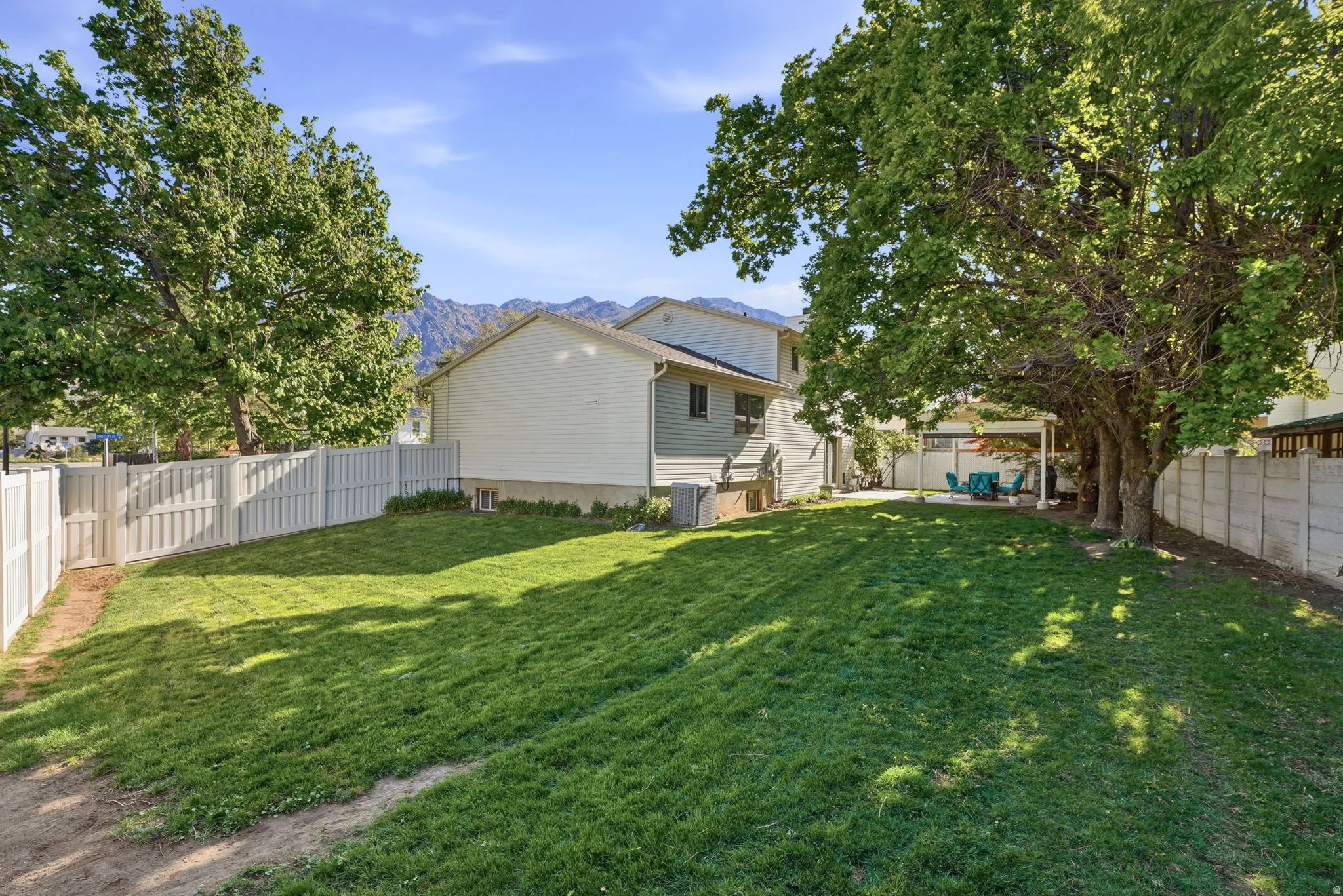 Fenced backyard with a mountain view