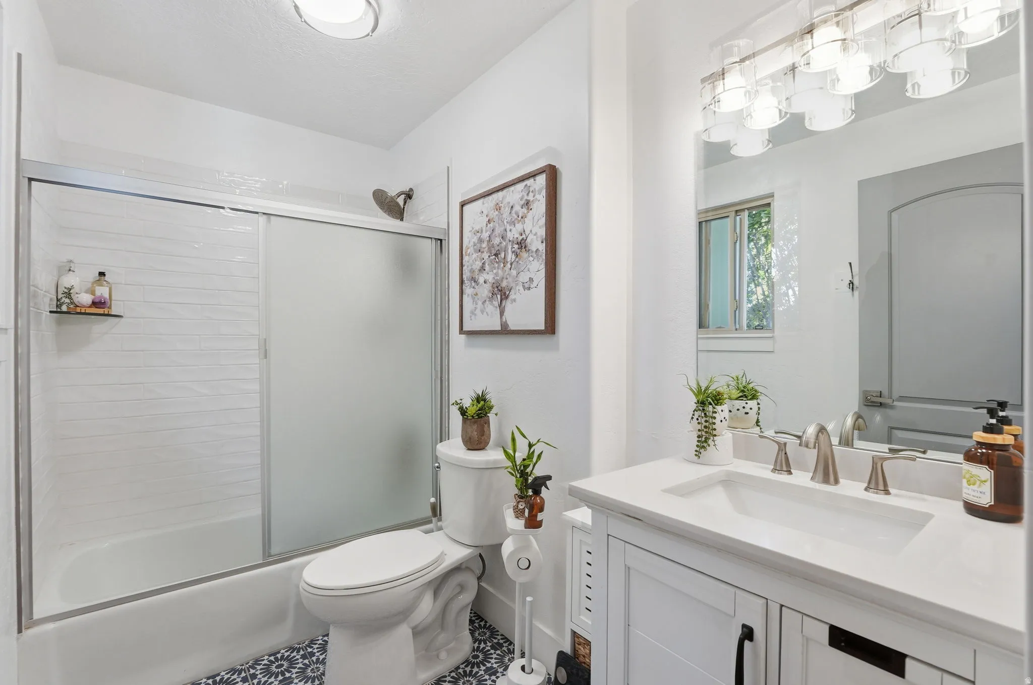 Full bathroom with vanity and shower / bath combination with glass door