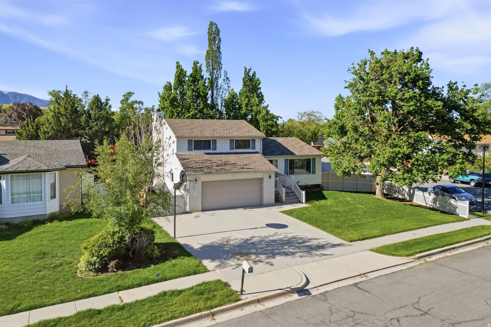 View of front of home featuring driveway, a garage, and brick siding