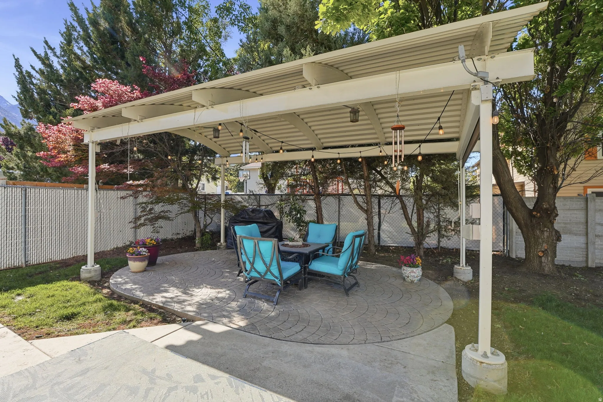 Fenced backyard with a patio area
