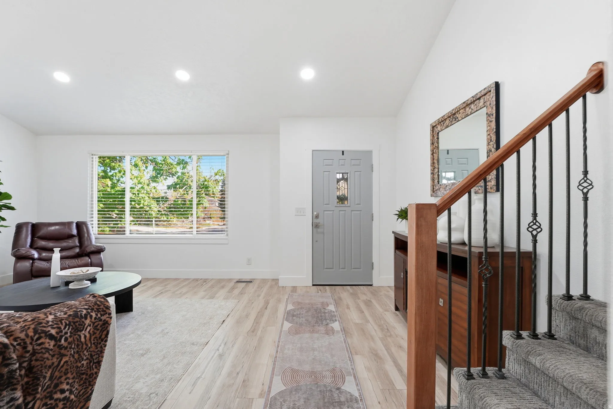 Entrance foyer with light wood finished floors, recessed lighting, and lofted ceiling