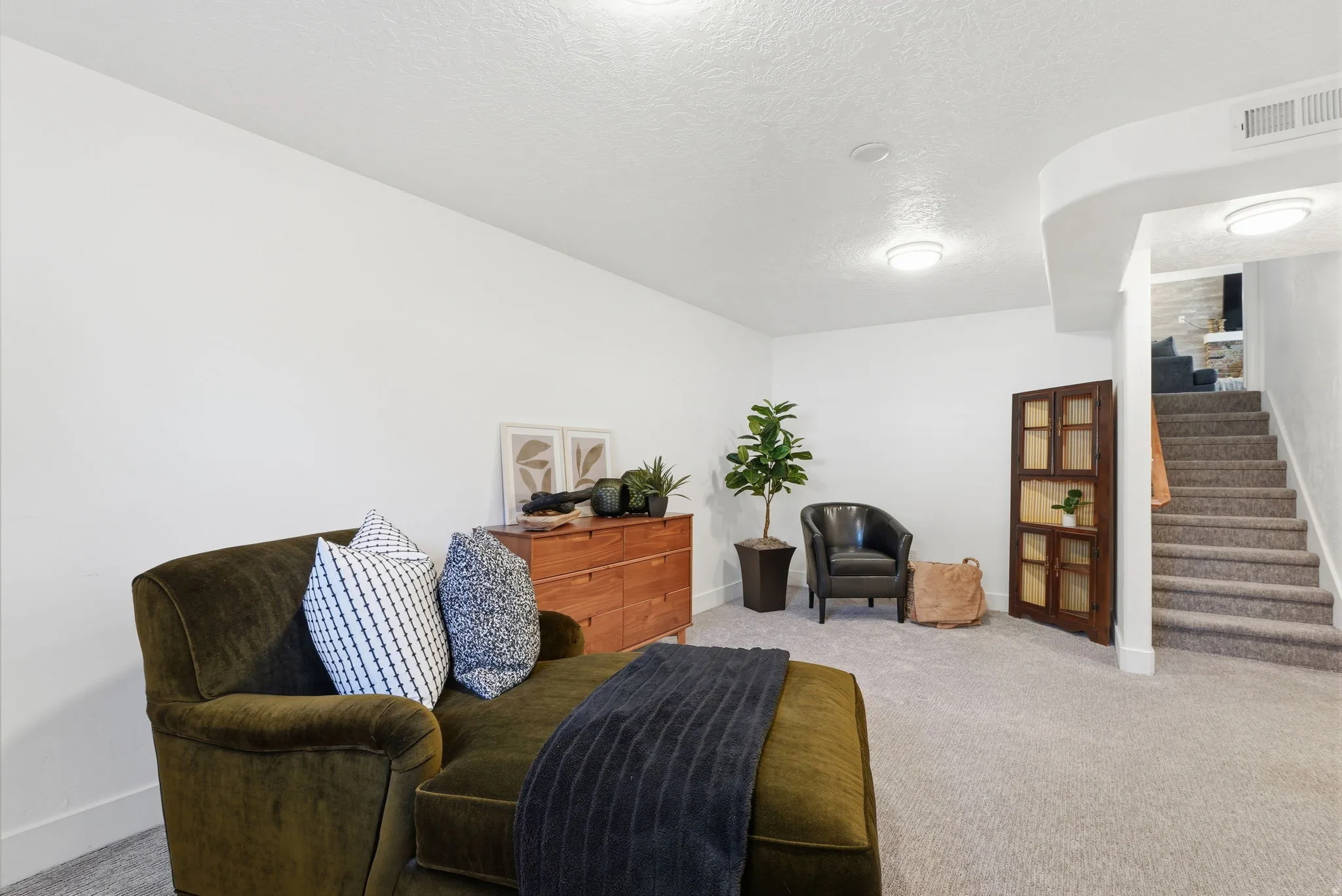 Sitting room with carpet flooring and a textured ceiling
