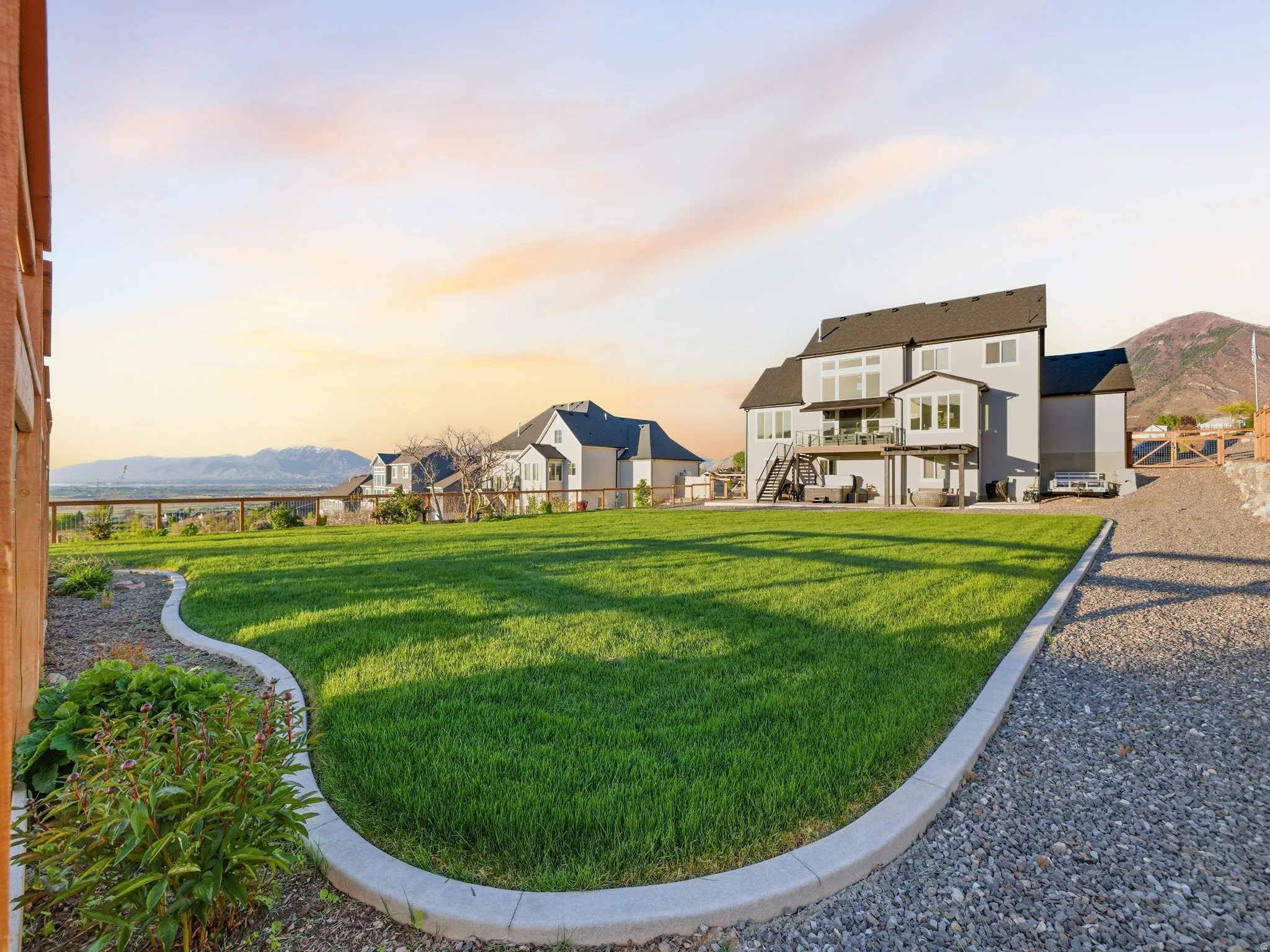 The backyard is fully fenced. The gravel drive surrounds the house giving you the ability to easily drive around the entire home.