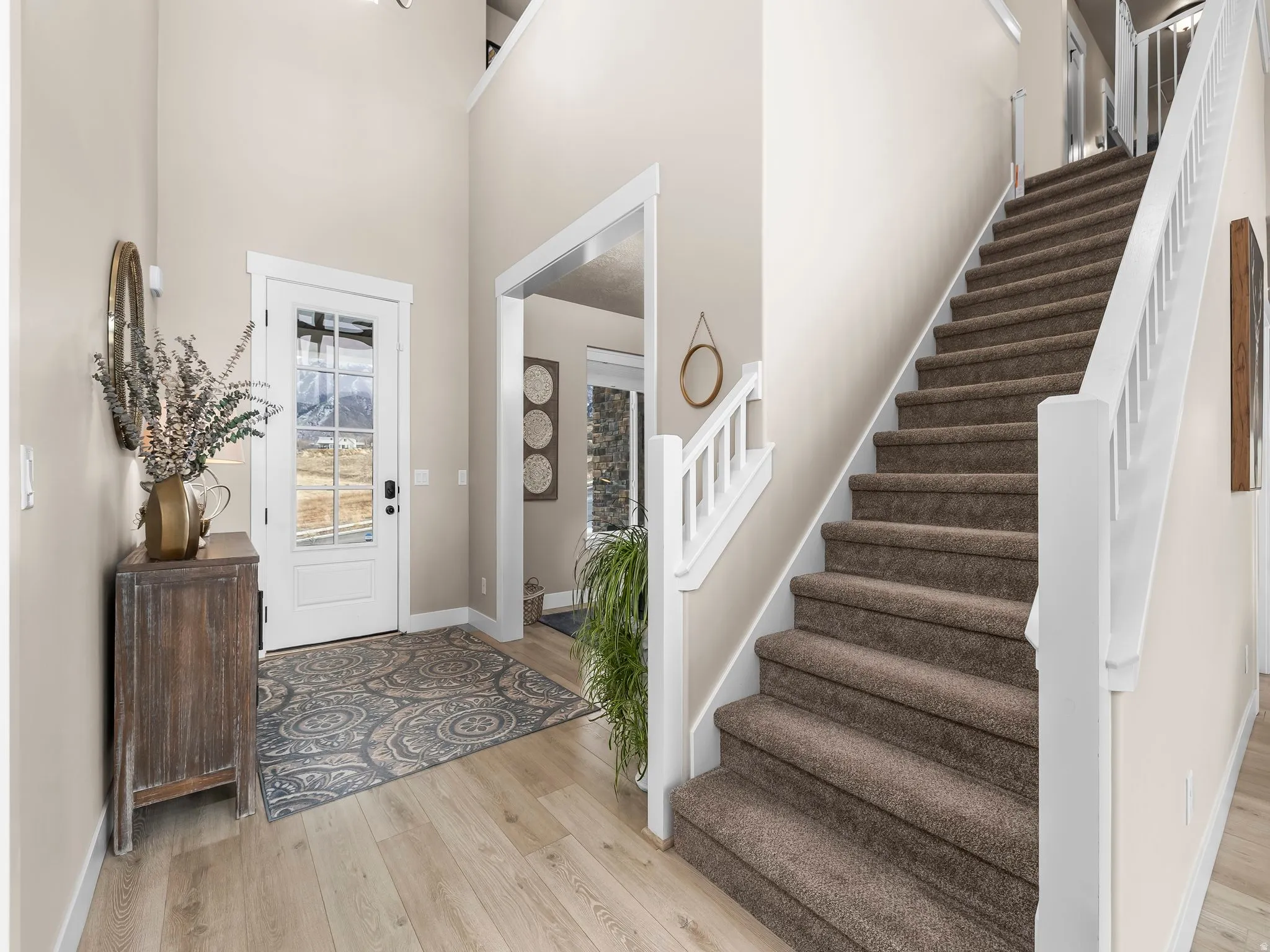 Entryway with light wood-style flooring and a high ceiling