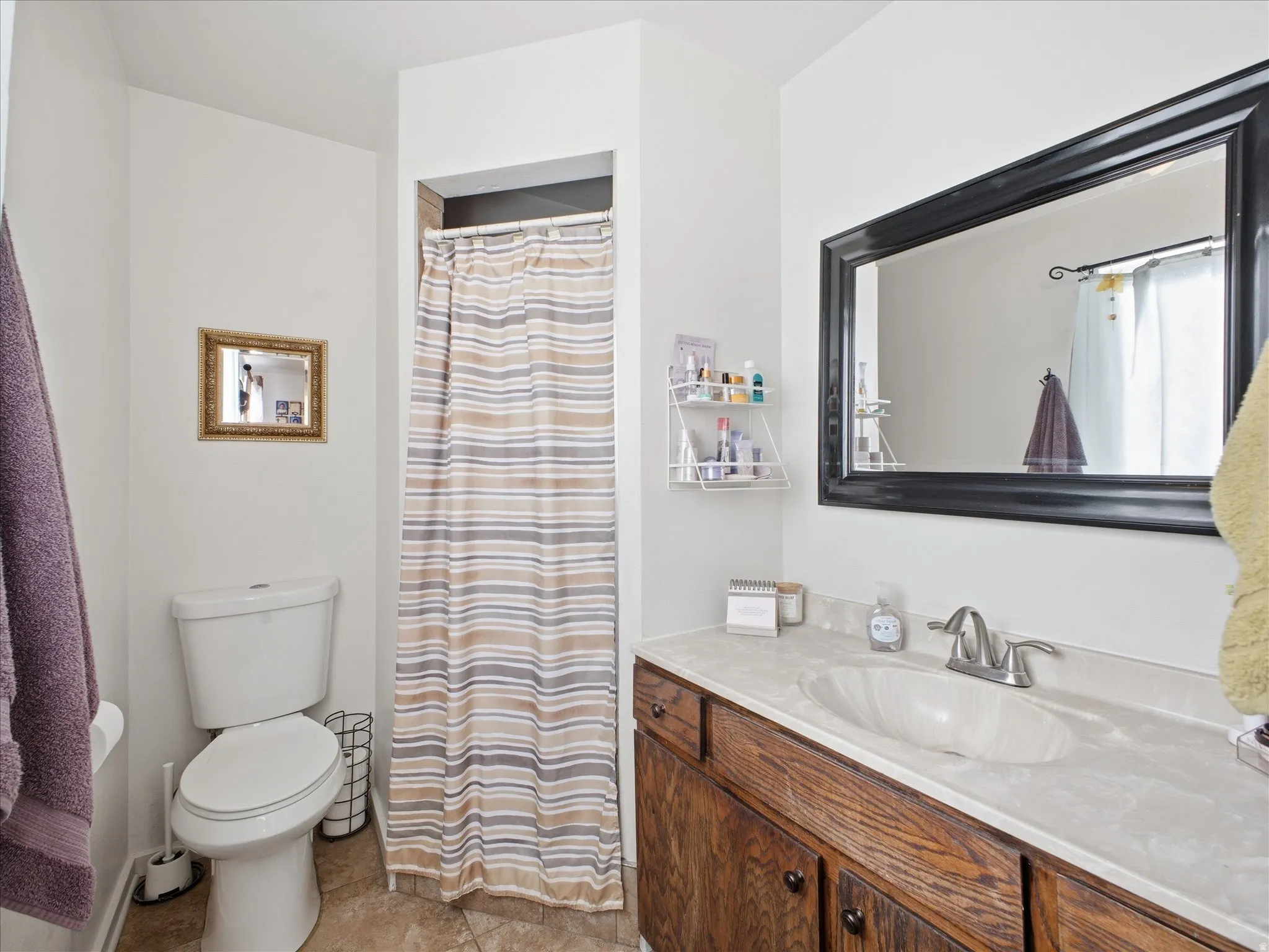Bathroom featuring vanity and a shower.