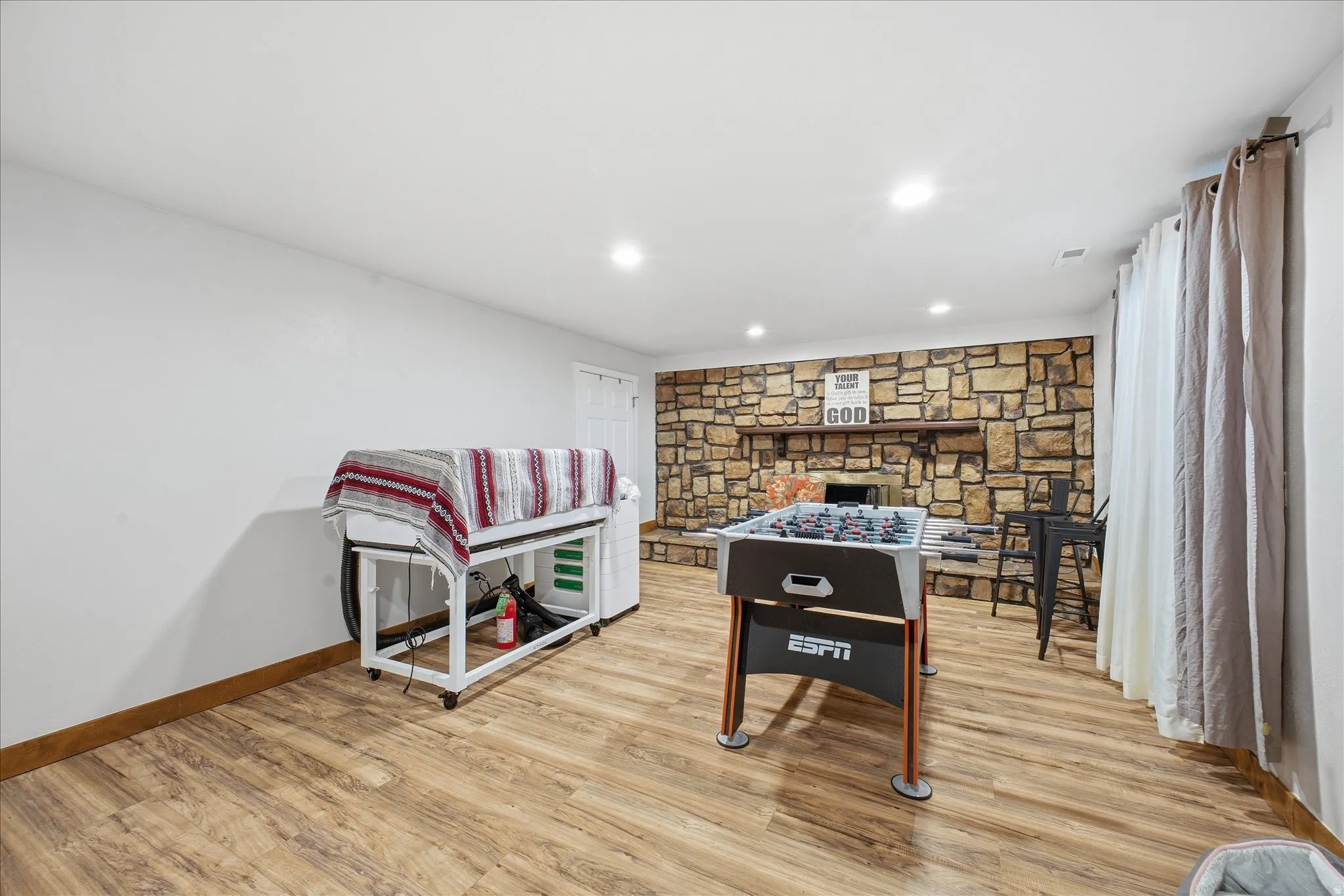 Game room featuring light wood-style floors and recessed lighting