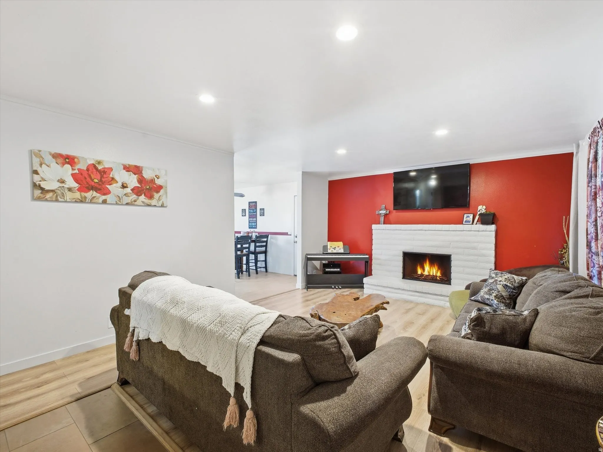 Living room with a fireplace, recessed lighting, and wood finished floors