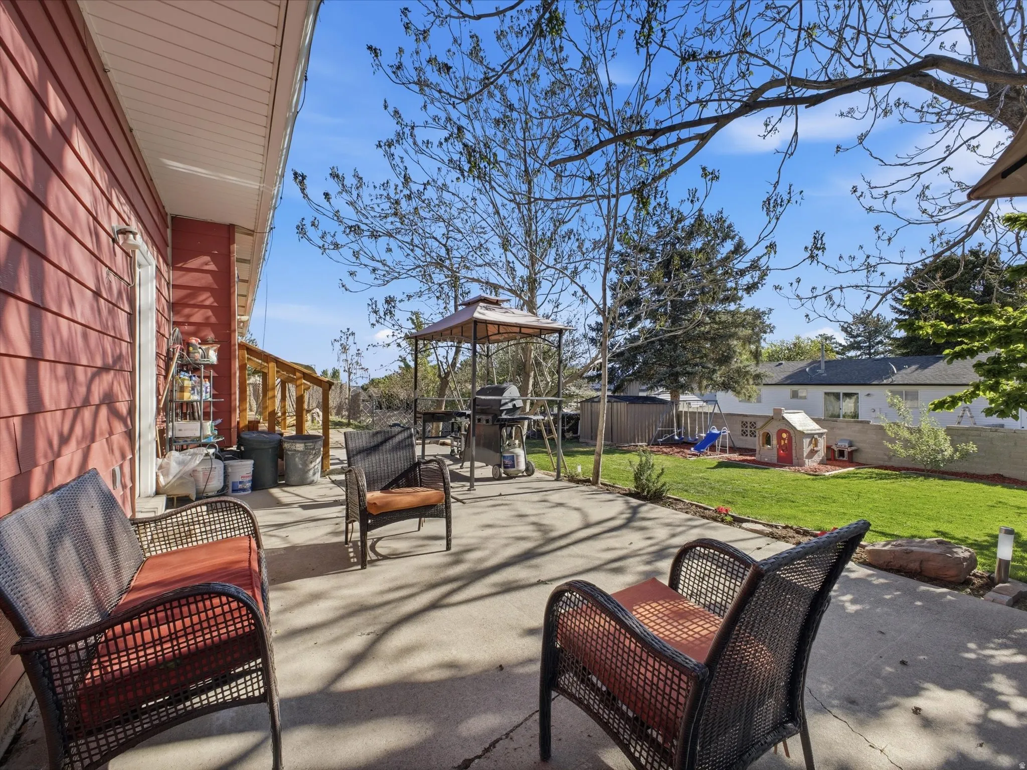 Fenced backyard with a patio, an outdoor lounge area, and grilling area