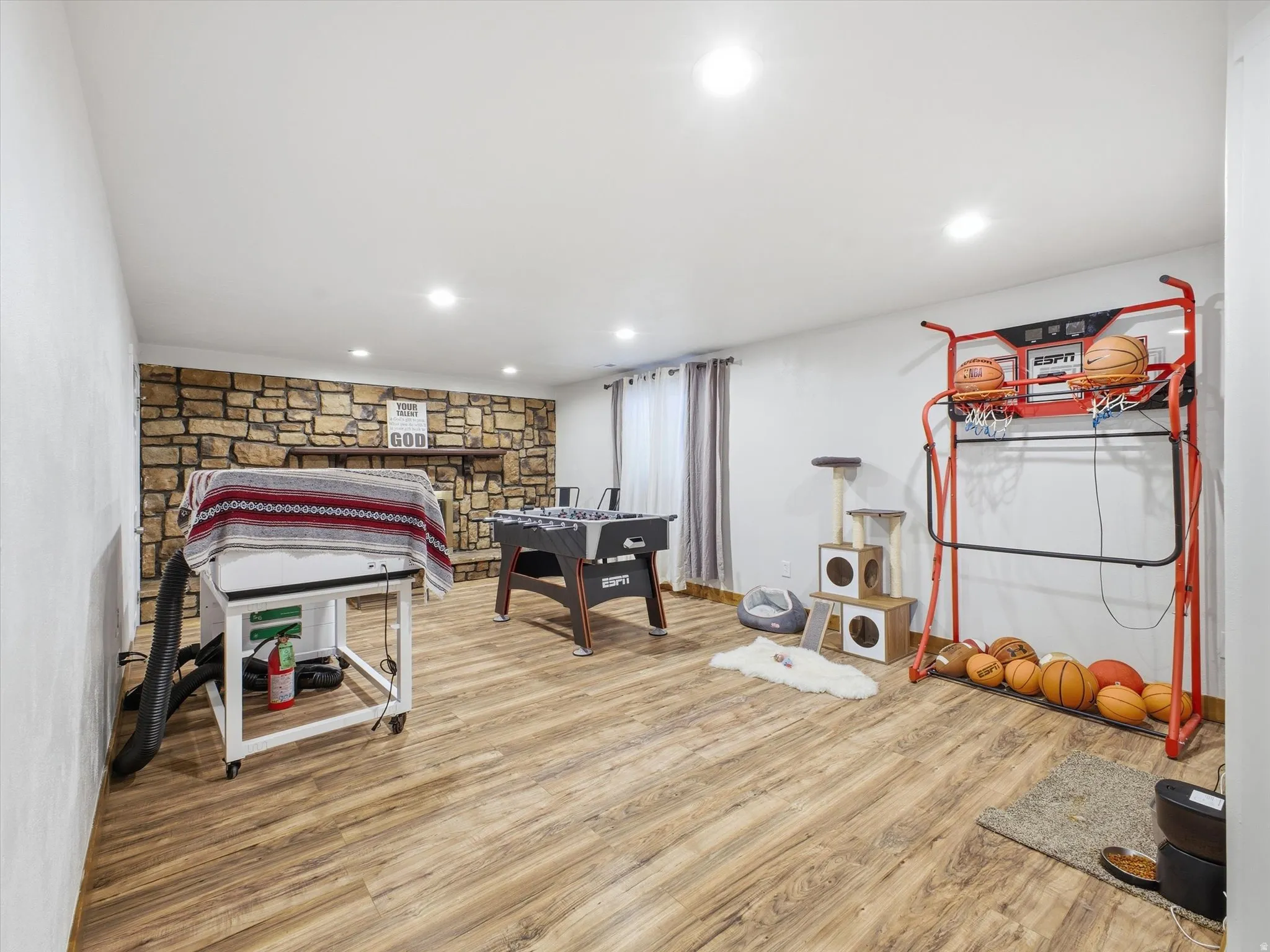 Family room with light wood finished floors and recessed lighting
