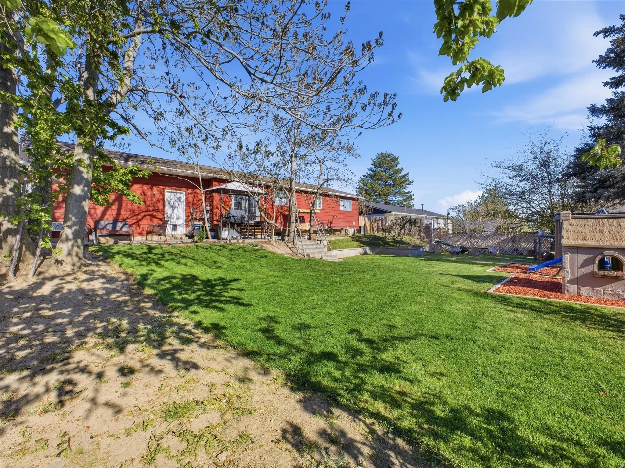 Back of property featuring a yard and a patio area