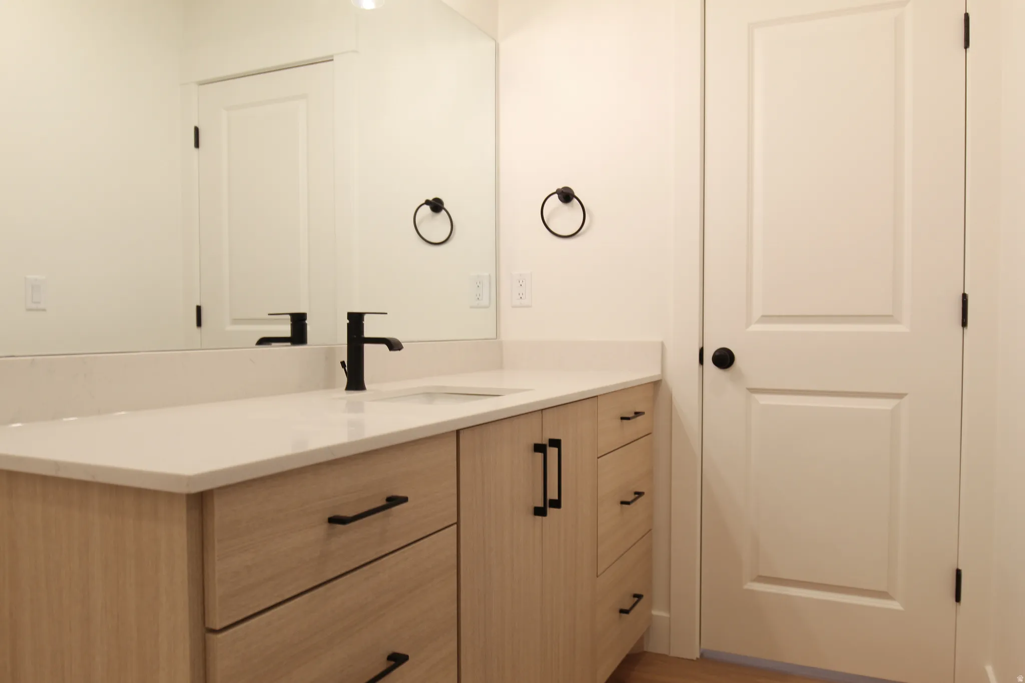 Bathroom with vanity and light wood finished floors