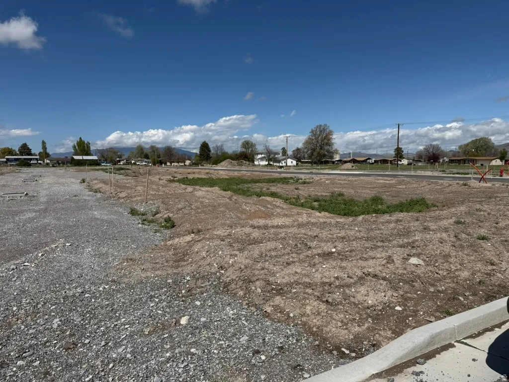 Expansive development lot featuring a graded surface and newly installed curb