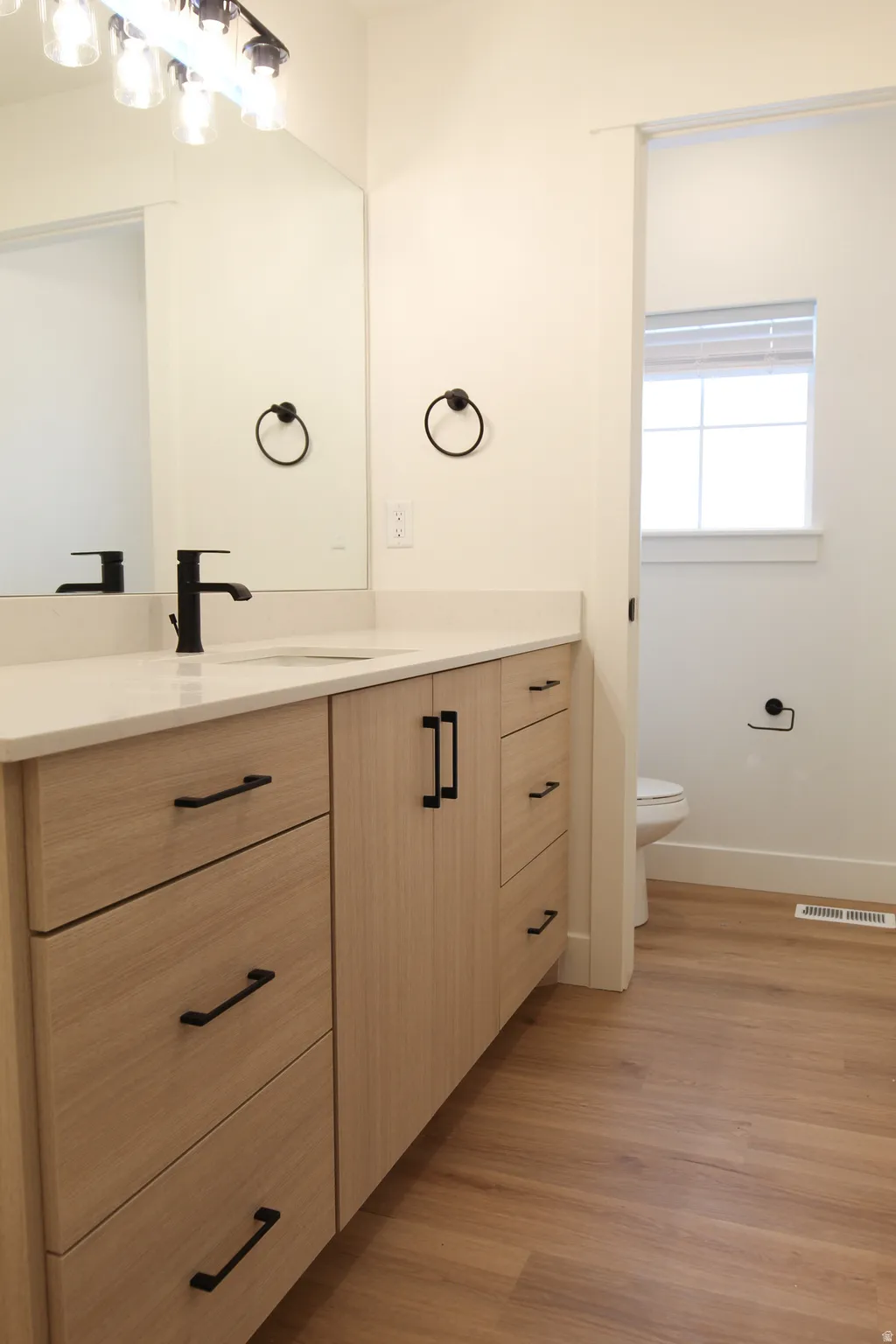 Bathroom with vanity and light wood finished floors