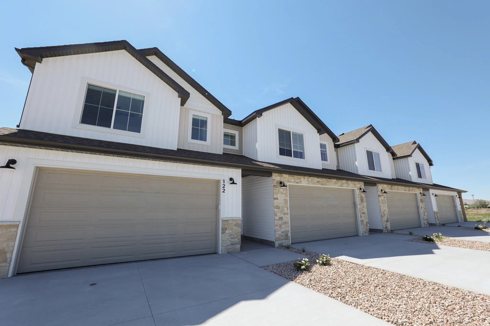 Modern townhome exterior with crisp white siding and dark trim