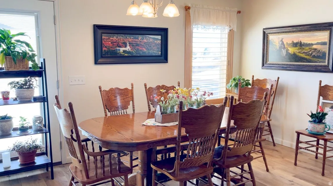 Dining space featuring wood finished floors and hanging lights