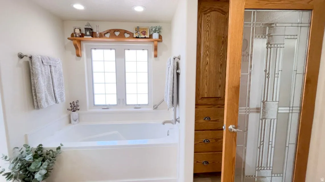 Full bathroom with a bath and recessed lighting