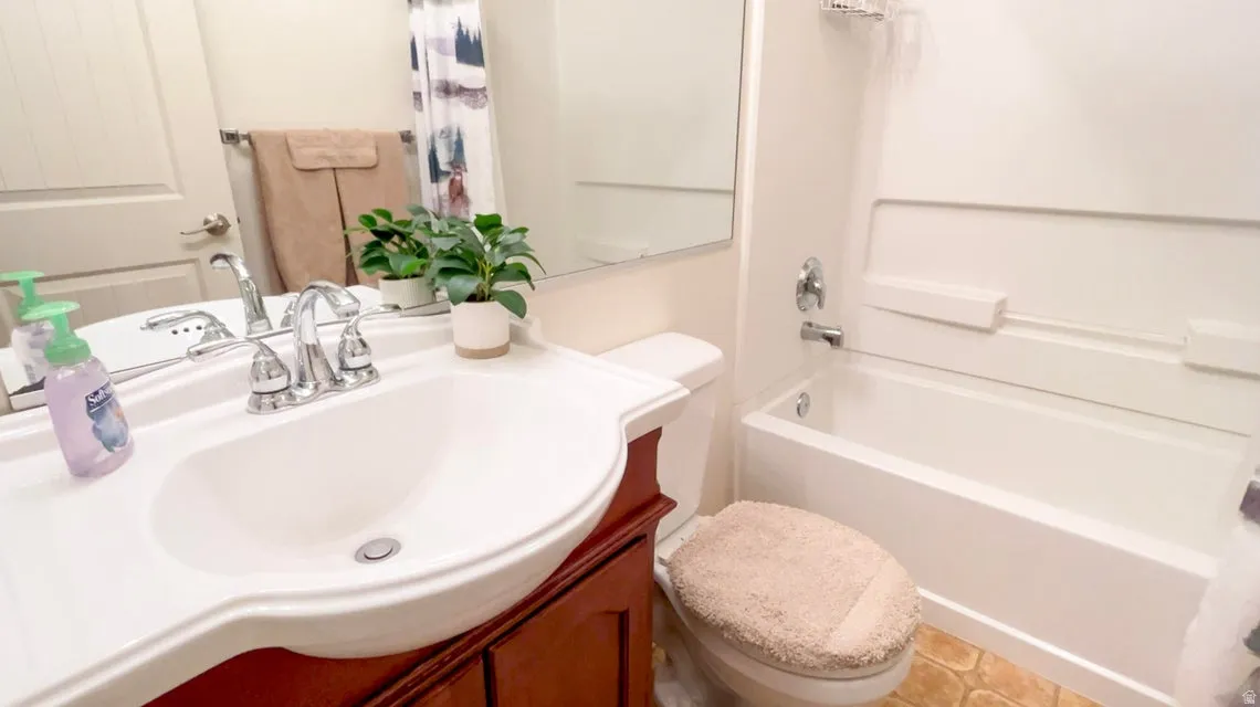 Bathroom with vanity and shower / tub combo