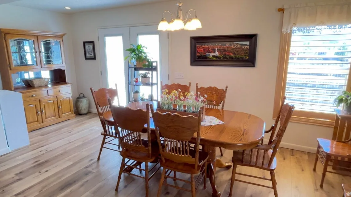 Dining space featuring light wood finished floors and suspended lighting