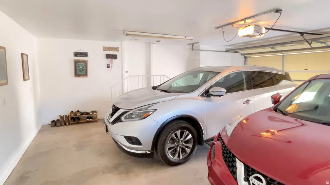 Garage with baseboards and a garage door opener
