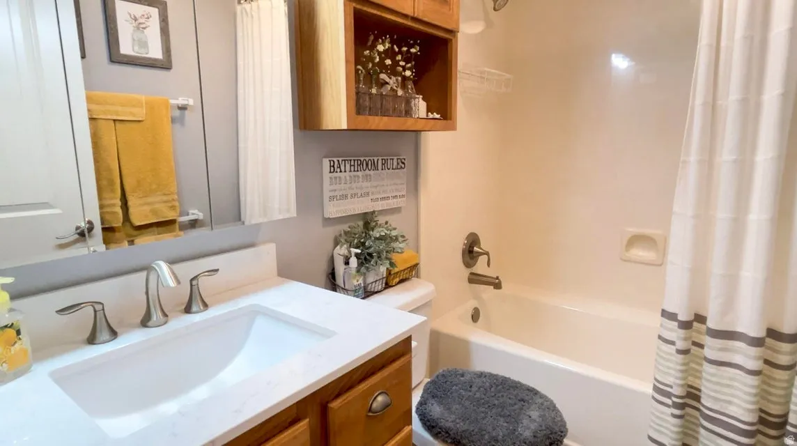 Bathroom featuring vanity and shower / tub combo