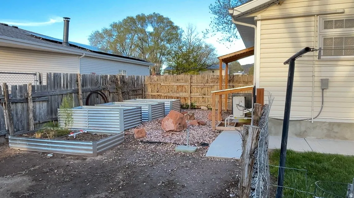 Fenced backyard with a garden