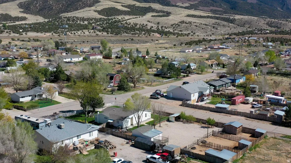 View of property location featuring nearby suburban area and a mountain backdrop