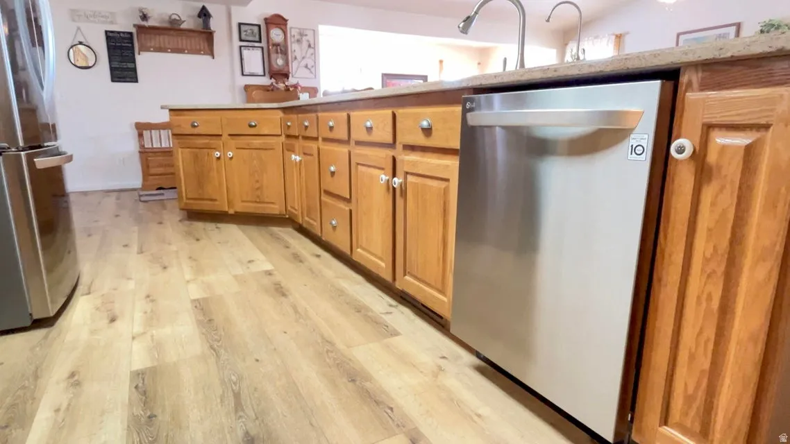 Kitchen with stainless steel appliances and wood finish cabinetry