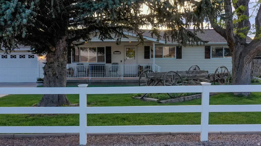 Ranch-style house featuring a fenced front yard and a porch