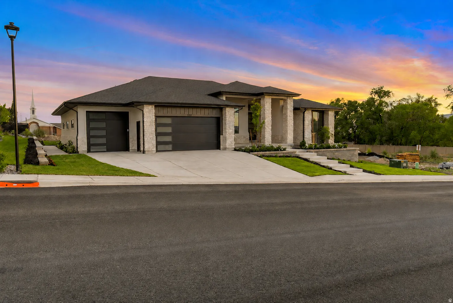 Modern facade featuring stone accents and stucco siding