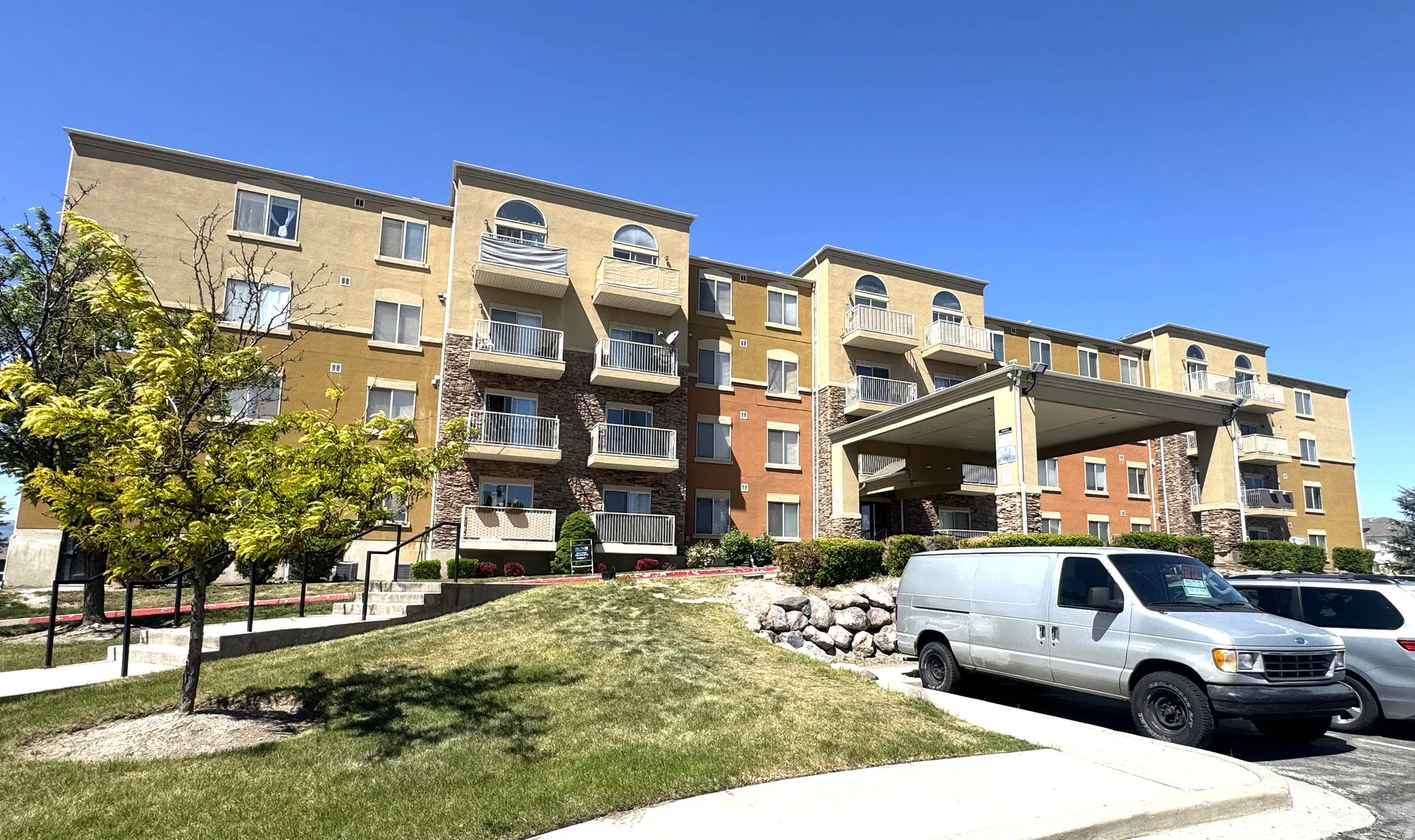 View of condo complex with parking