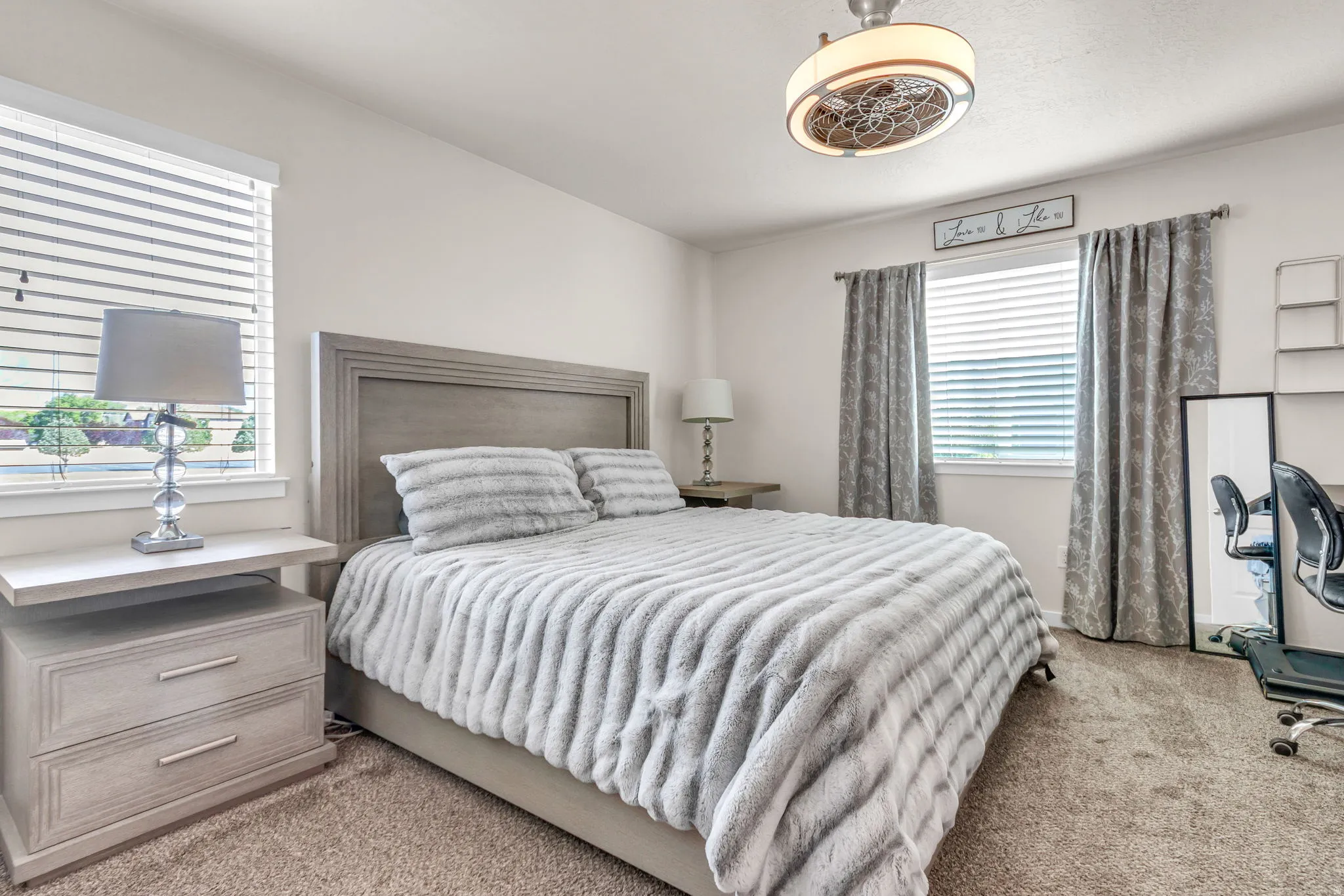 Bedroom featuring light carpet
