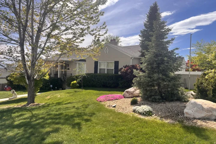 View of front of house with stucco siding and a chimney