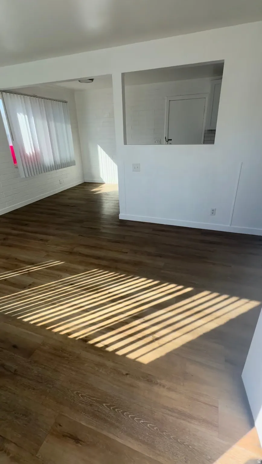 Empty room with dark wood-type flooring