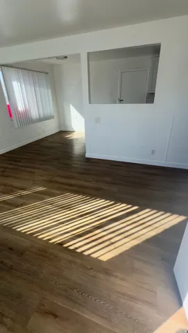 Empty room with dark wood-type flooring