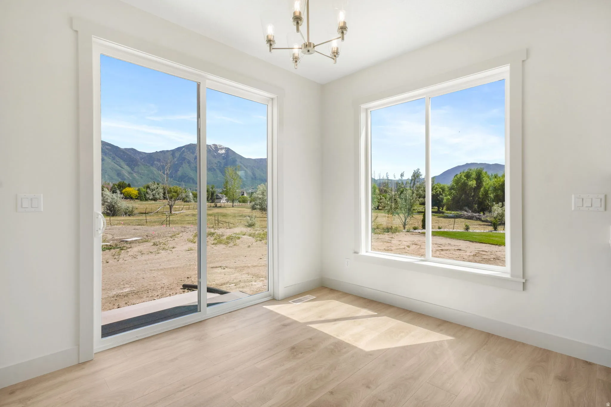 Bright interior space featuring a sliding glass door and large window
